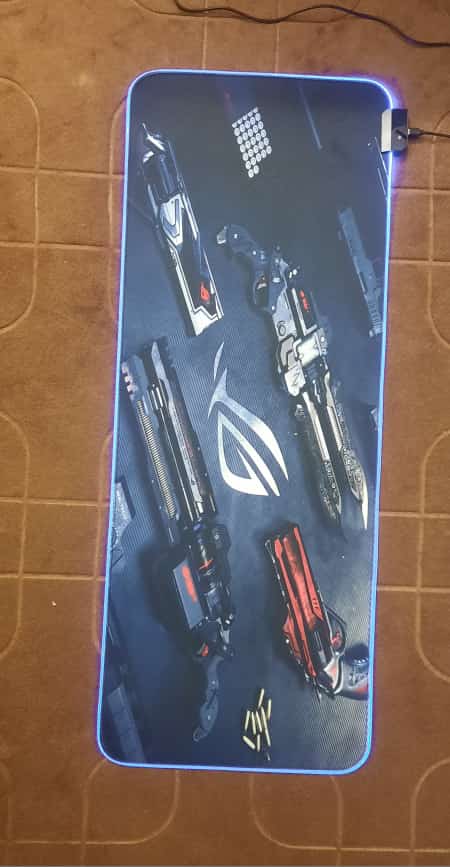 ROG Weapons Gaming Mouse Pad lit up on desk